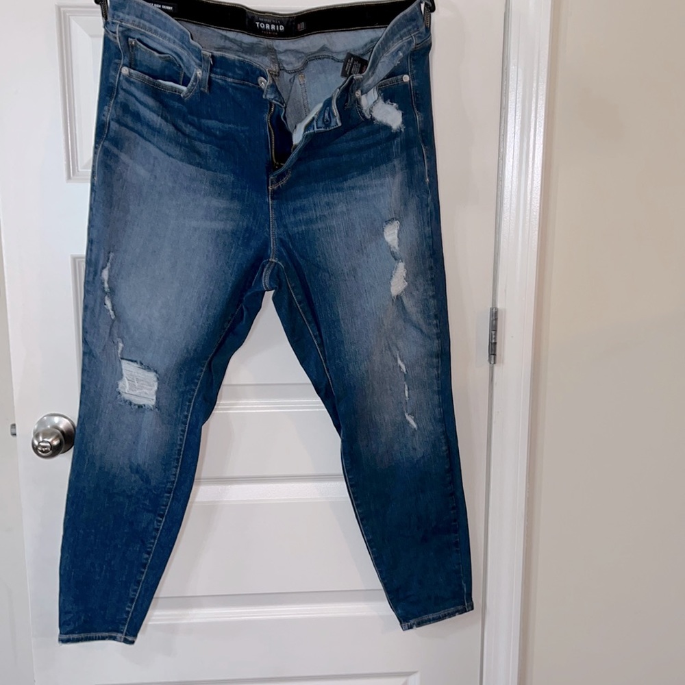 Medium wash blue skinny jeans from torrid. Destructed front gently used